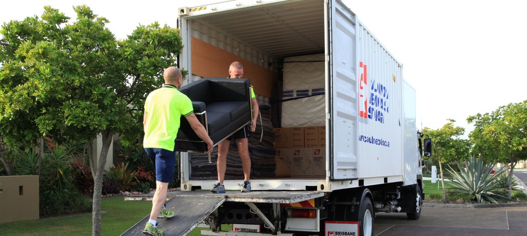Movers Carrying a Black Couch — Caloundra Removals & Storage in Sunshine Coast, QLD