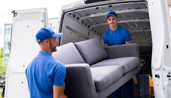 Removalists Lifting Grey Couch Into Truck — Caloundra Removals & Storage in Sunshine Coast, QLD