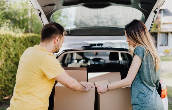Couple Loading the Car With Moving Boxes — Caloundra Removals & Storage in Sunshine Coast, QLD
