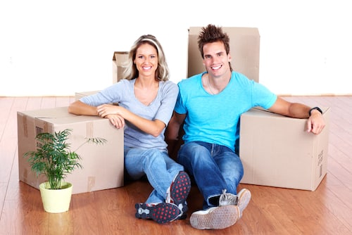Couple Sitting on the Floor After Moving from Brisbane to Sydney