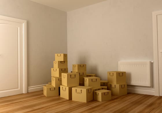 Cardboard Boxes Stacked in Corner of Empty Room — Caloundra Removals & Storage in Sunshine Coast, QLD
