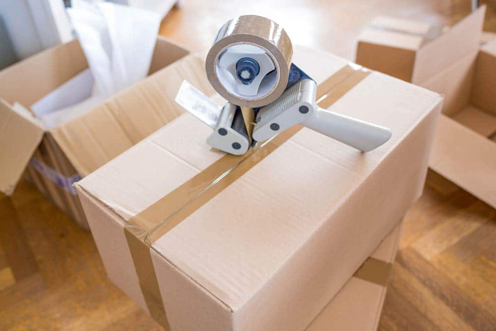 Tape Dispenser With Packing Tape On Top Of A Box