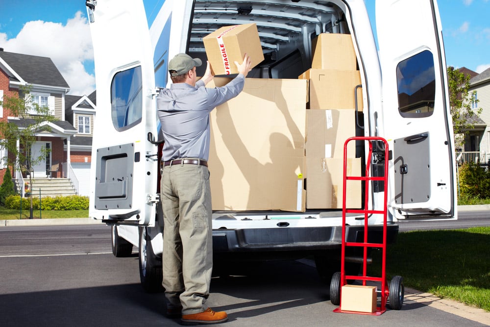A Man Unloading Boxes A Man Unloading Boxes