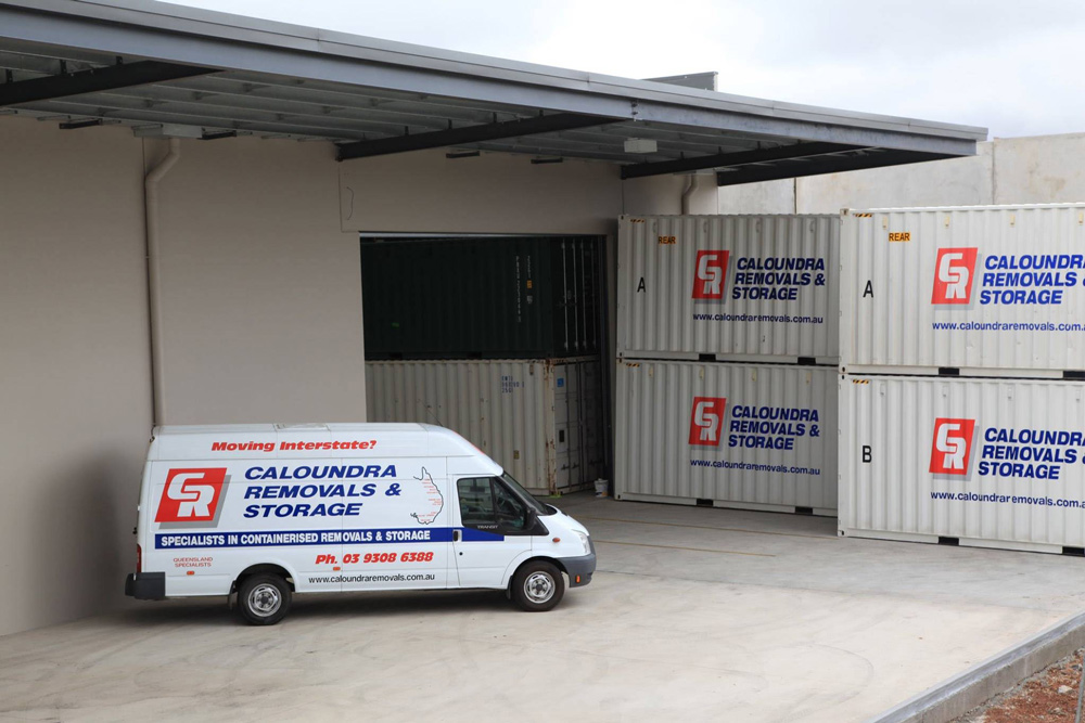 Parked van near large storage containers for moving