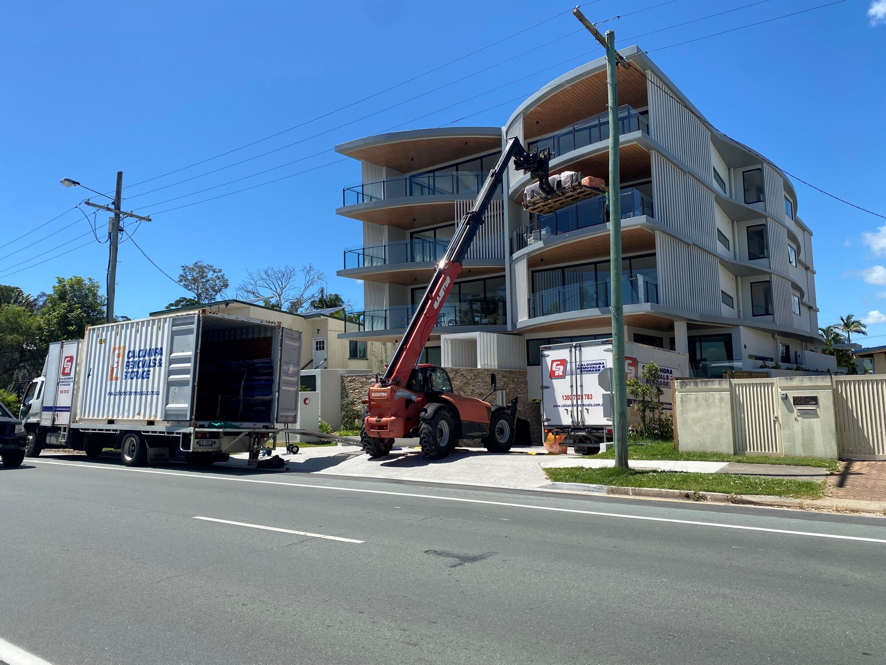 Furniture Removal Lift Equipment Through Building Window — Caloundra Removals & Storage in Sunshine Coast, QLD