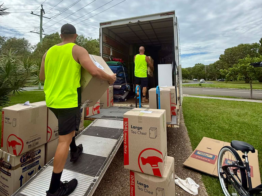 Removalists Loading Storage Boxes in Truck for Relocation