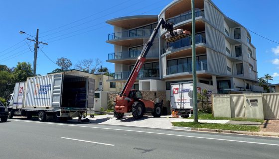 Furniture Removal Lift Equipment Through Building Window — Caloundra Removals & Storage in Sunshine Coast, QLD