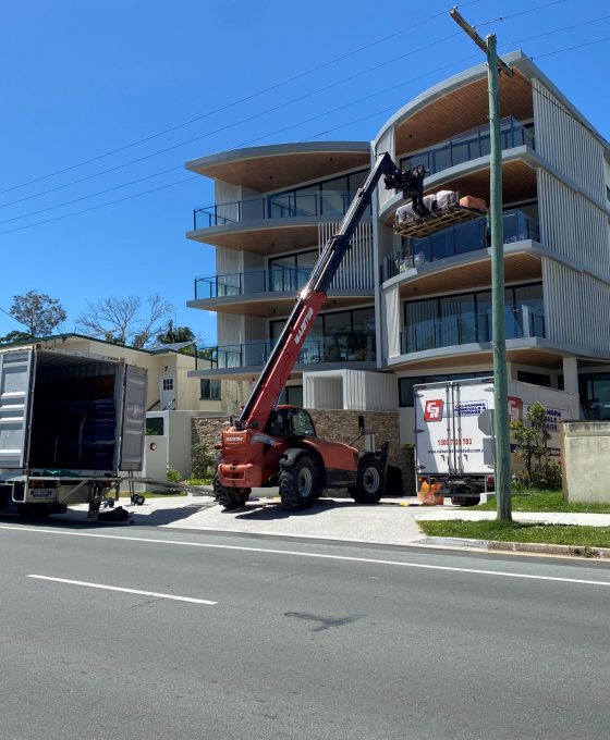 Furniture Removal Lift Equipment Through Building Window — Caloundra Removals & Storage in Sunshine Coast, QLD