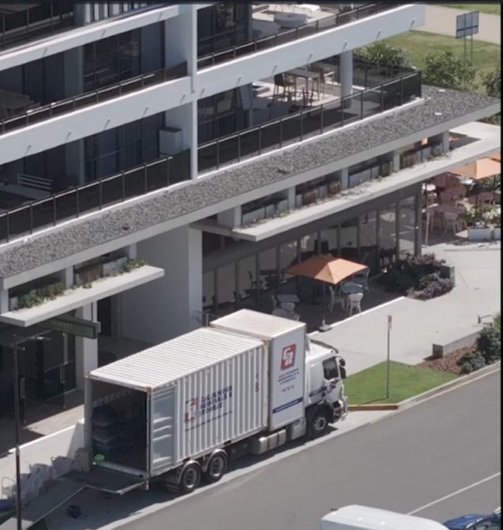 Backdoor Loading Of Removal Truck In Front Of Building — Caloundra Removals & Storage in Sunshine Coast, QLD