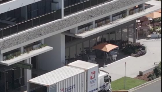 Backdoor Loading Of Removal Truck In Front Of Building — Caloundra Removals & Storage in Sunshine Coast, QLD